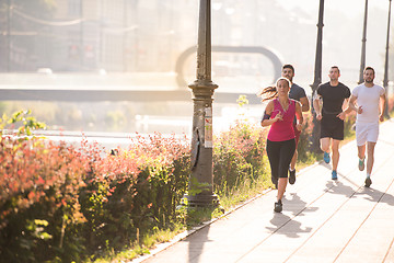 Image showing group of young people jogging in the city