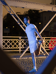 Image showing man jogging across the bridge in the city