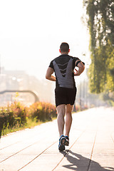 Image showing man jogging at sunny morning