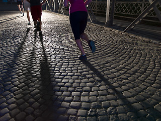 Image showing young people jogging across the bridge