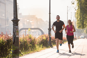 Image showing young couple jogging  in the city