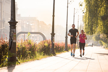 Image showing young couple jogging  in the city