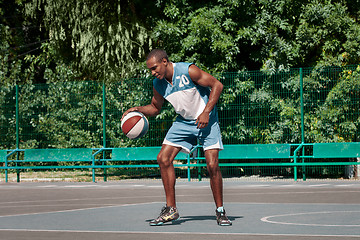 Image showing Picture of young confused african basketball player practicing