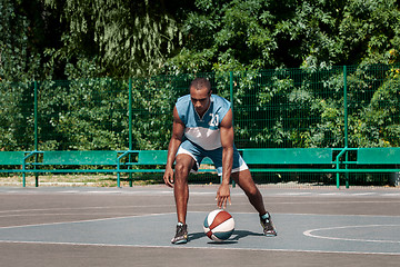 Image showing Picture of young confused african basketball player practicing