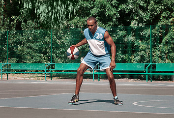 Image showing Picture of young confused african basketball player practicing