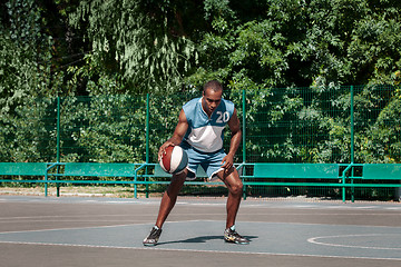 Image showing Picture of young confused african basketball player practicing