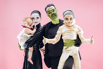 Image showing Halloween Family. Happy Father, Mother and Children Girls in Halloween Costume and Makeup