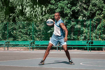 Image showing Picture of young confused african basketball player practicing