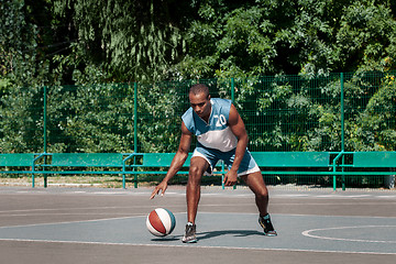 Image showing Picture of young confused african basketball player practicing