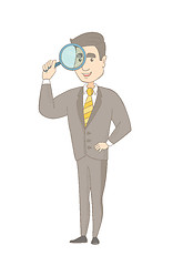 Image showing Young caucasian businessman with magnifying glass.