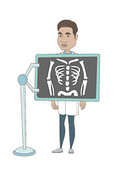 Image showing Hispanic roentgenologist during x ray procedure.