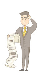 Image showing Young caucasian accountant holding a long bill.