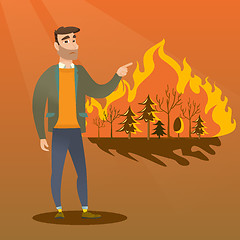 Image showing Man standing on the background of wildfire.