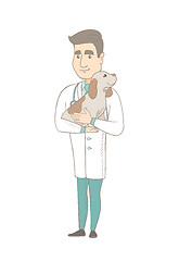 Image showing Young caucasian veterinarian with dog in hands.