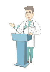 Image showing Caucasian doctor giving a speech from tribune.