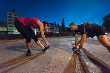 Image showing couple warming up and stretching