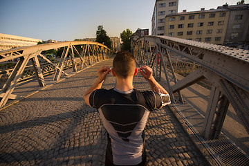 Image showing portrait of a jogging man at sunny morning