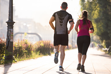 Image showing young couple jogging  in the city