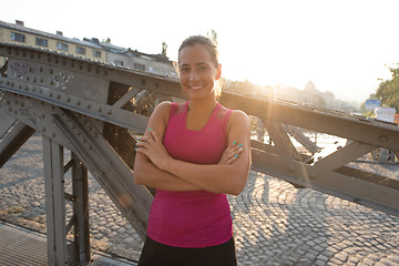 Image showing portrait of a jogging woman at sunny morning