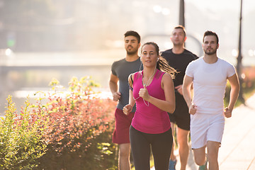 Image showing group of young people jogging in the city