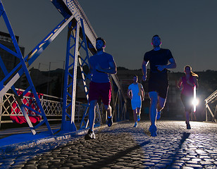 Image showing young people jogging across the bridge