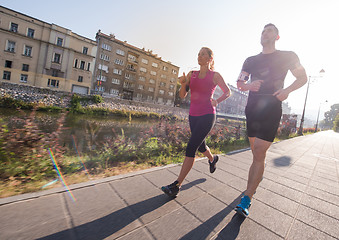 Image showing young couple jogging  in the city