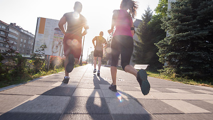 Image showing group of young people jogging in the city