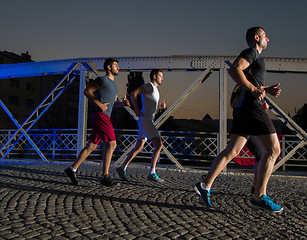 Image showing young people jogging across the bridge