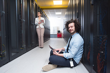 Image showing young technicians working together on servers