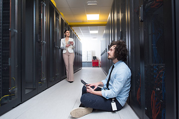 Image showing young technicians working together on servers