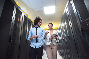 Image showing engineer showing working data center server room to female chief