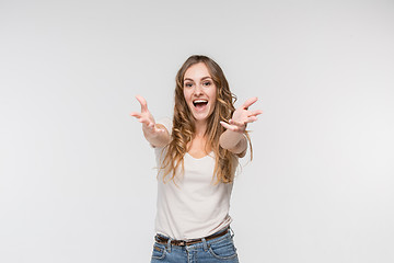 Image showing Beautiful female half-length portrait isolated on studio backgroud. The young emotional surprised woman