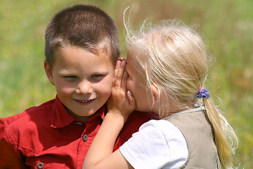 Image showing Whispering and smiling