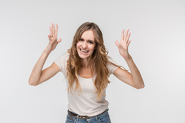 Image showing Beautiful female half-length portrait isolated on studio backgroud. The young emotional surprised woman