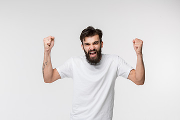 Image showing Winning success man happy ecstatic celebrating being a winner. Dynamic energetic image of male model