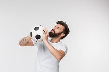 Image showing Young soccer player with ball in front of white background