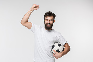 Image showing Young soccer player with ball in front of white background