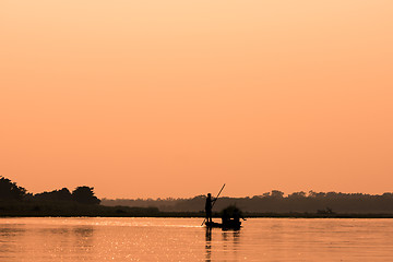 Image showing Men in a boat on a river silhouette