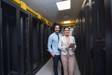 Image showing engineer showing working data center server room to female chief