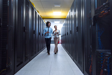 Image showing engineer showing working data center server room to female chief