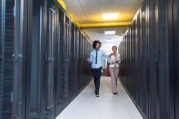 Image showing engineer showing working data center server room to female chief