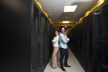 Image showing engineer showing working data center server room to female chief