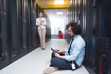 Image showing young technicians working together on servers