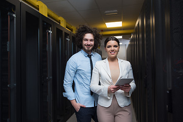 Image showing engineer showing working data center server room to female chief