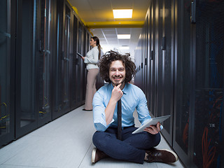 Image showing young technicians working together on servers