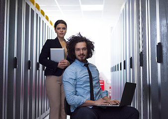 Image showing Team of young technicians working together on servers