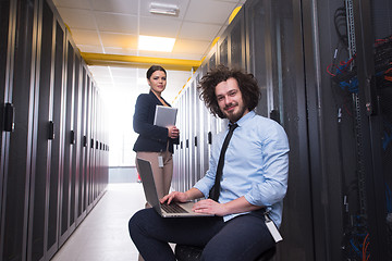 Image showing Team of young technicians working together on servers