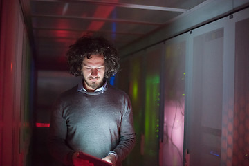 Image showing IT engineer working on a tablet computer in server room