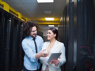 Image showing engineer showing working data center server room to female chief