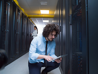 Image showing young technicians working together on servers